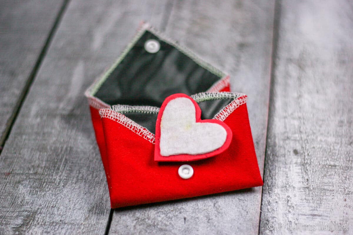 Folded up chalkboard heart with felt and craft foam eraser on top.