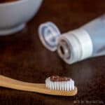 mint chocolate homemade toothpaste on a bamboo toothbrush