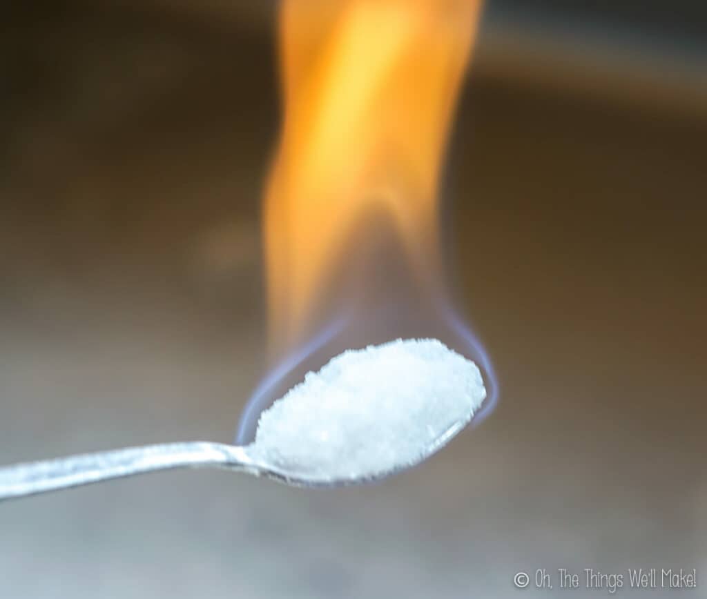 burning a calcium acetate mixture on a spoon