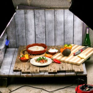 A homemade pallet "studio" with artificial lights set up to take pictures of homemade carnitas.