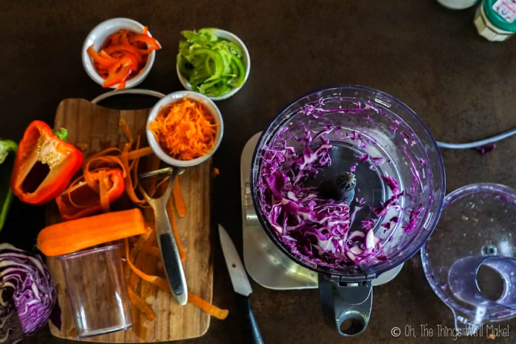 Shredding red cabbage in a food processor.