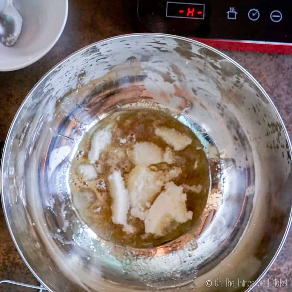 Overhead view of gelatin in a bowl in a honey mixture.