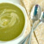Overhead view of a creamy green soup with asparagus and nettles.
