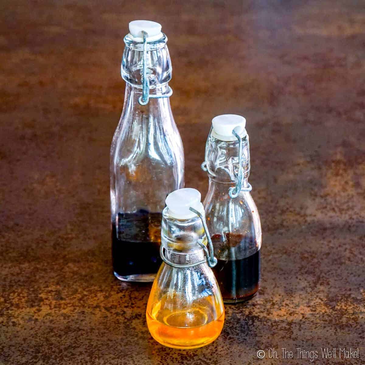 3 small glass bottles with homemade food colorings.