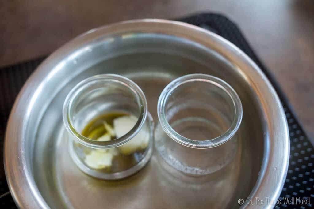 Heating the water in one jar and the oil and emulsifier in another jar in a water bath, to make a lotion