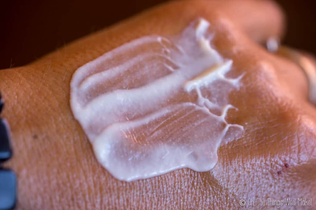 A lotion made with Plantasense HE spread over a hand, showing the texture.