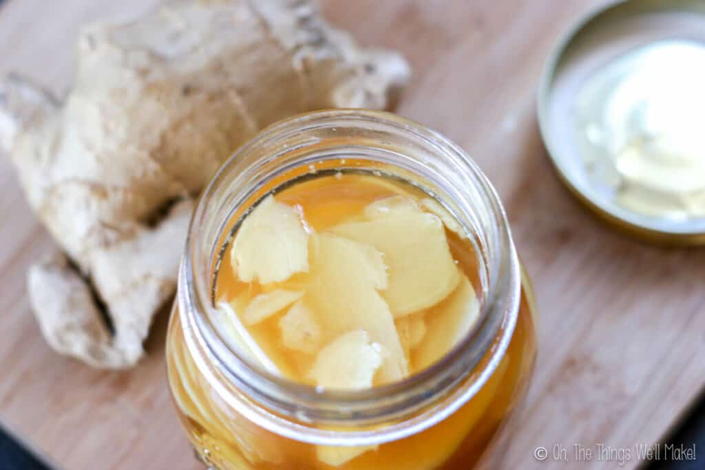 overhead view of an open jar of uncolored pickled ginger.