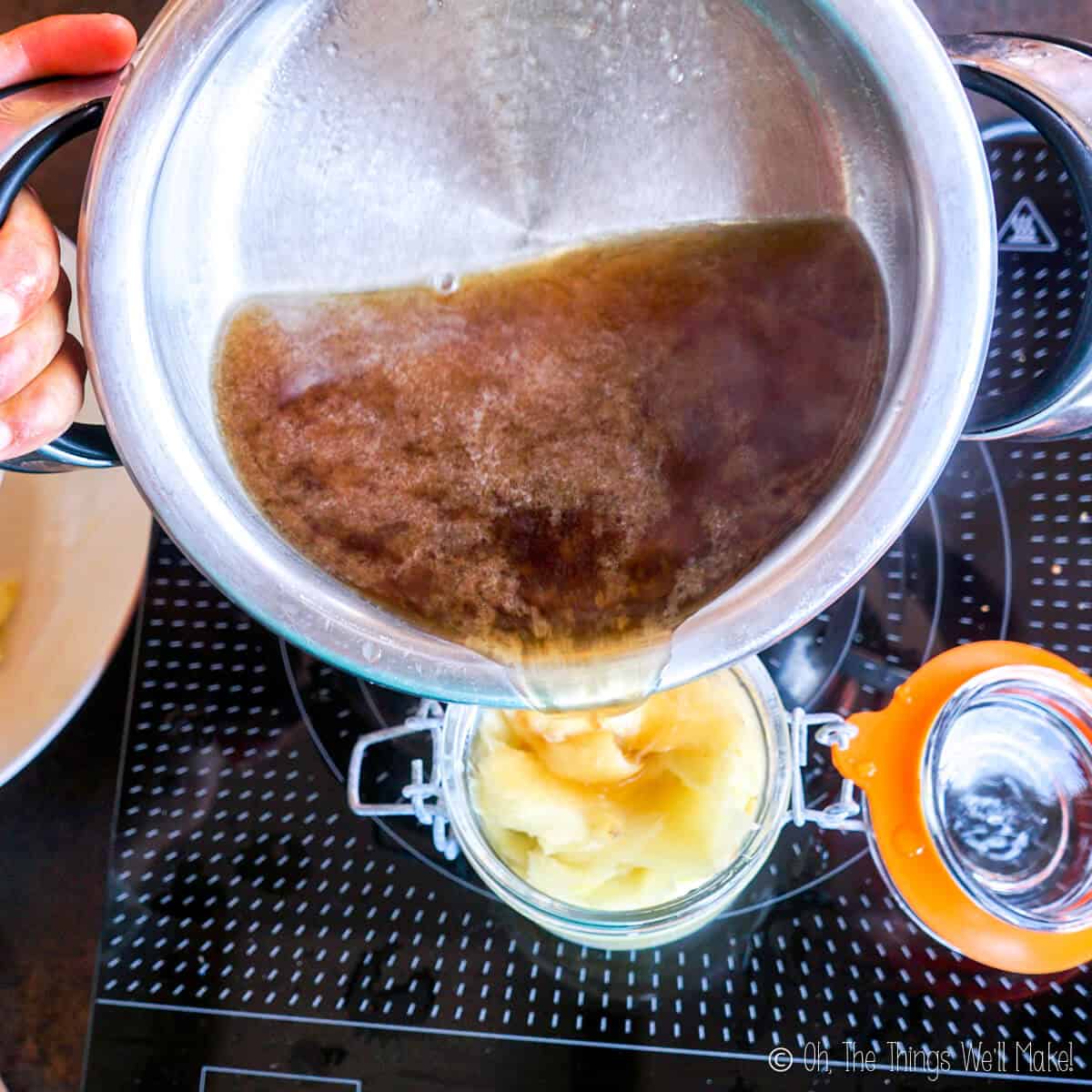 Pouring the vinegar mixture into a jar with the cooked ginger.