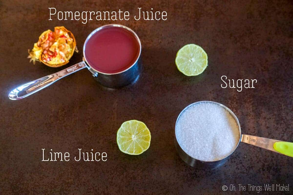 Overhead view of the ingredients needed to make homemade grenadine: pomegranate juice, sugar, and lime juice.