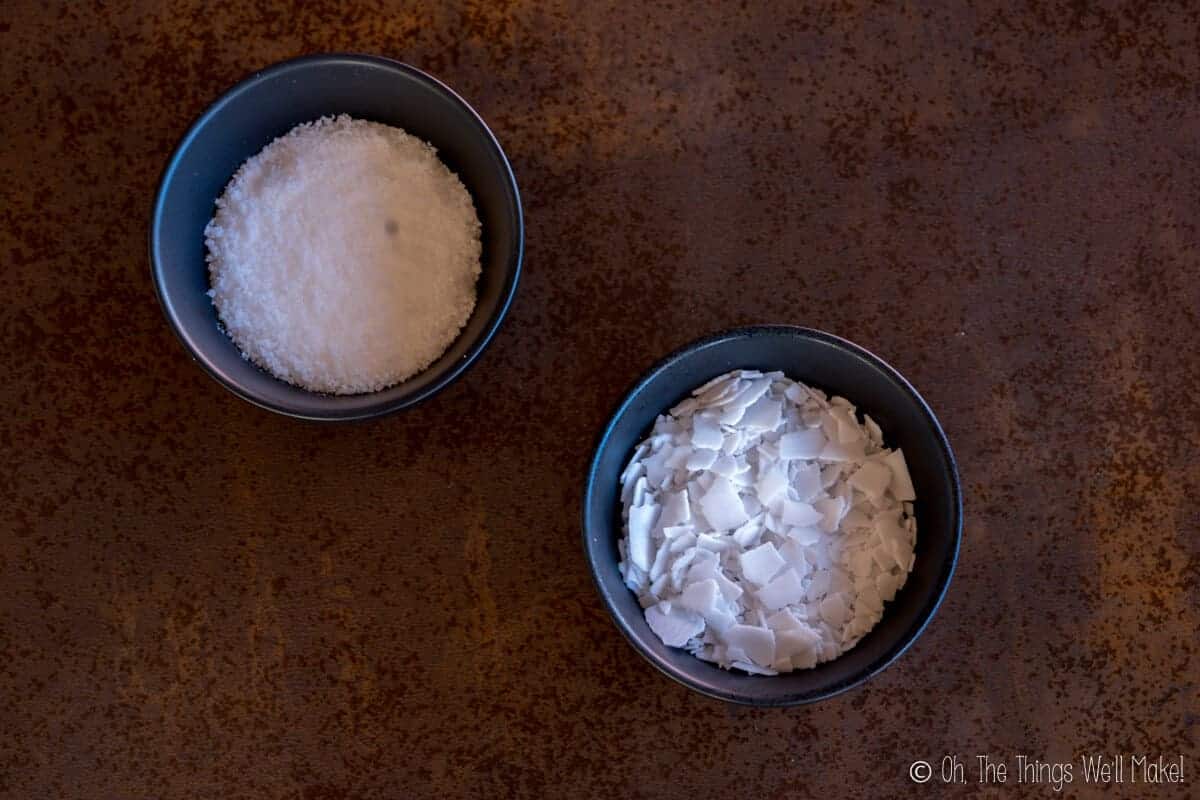 Overhead view of 2 bowls of lye, one with sodium hydroxide on the left and potassium hydroxide on the right