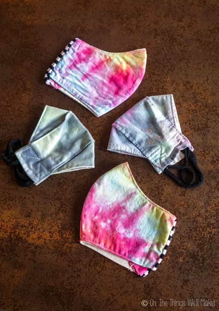 Overhead view of 4 tie-dyed face masks