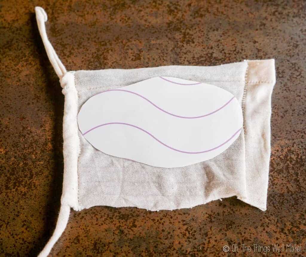 transfer paper face down over a rectangle of cloth