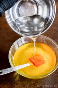 Pouring a lye solution into a bowl with oil, the mixture becomes opaque.