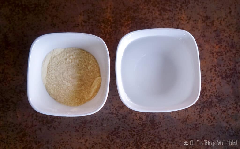 A bowl of goat milk powder next to a bowl of water