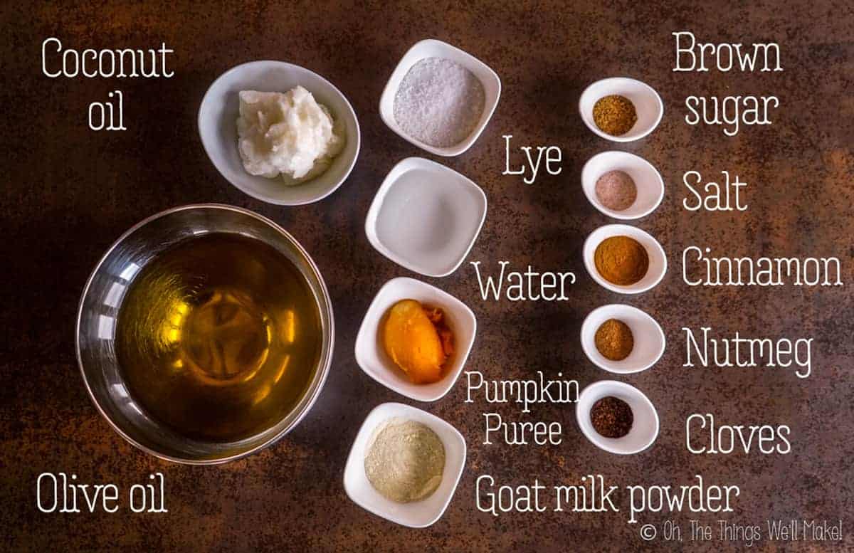 Overhead view of the oils, lye, water, powdered goat milk, pumpkin, and the spices needed to make an easy pumpkin spice soap.