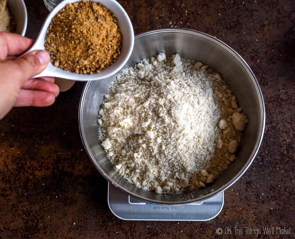 Pouring sugar into a bowl with almond flour