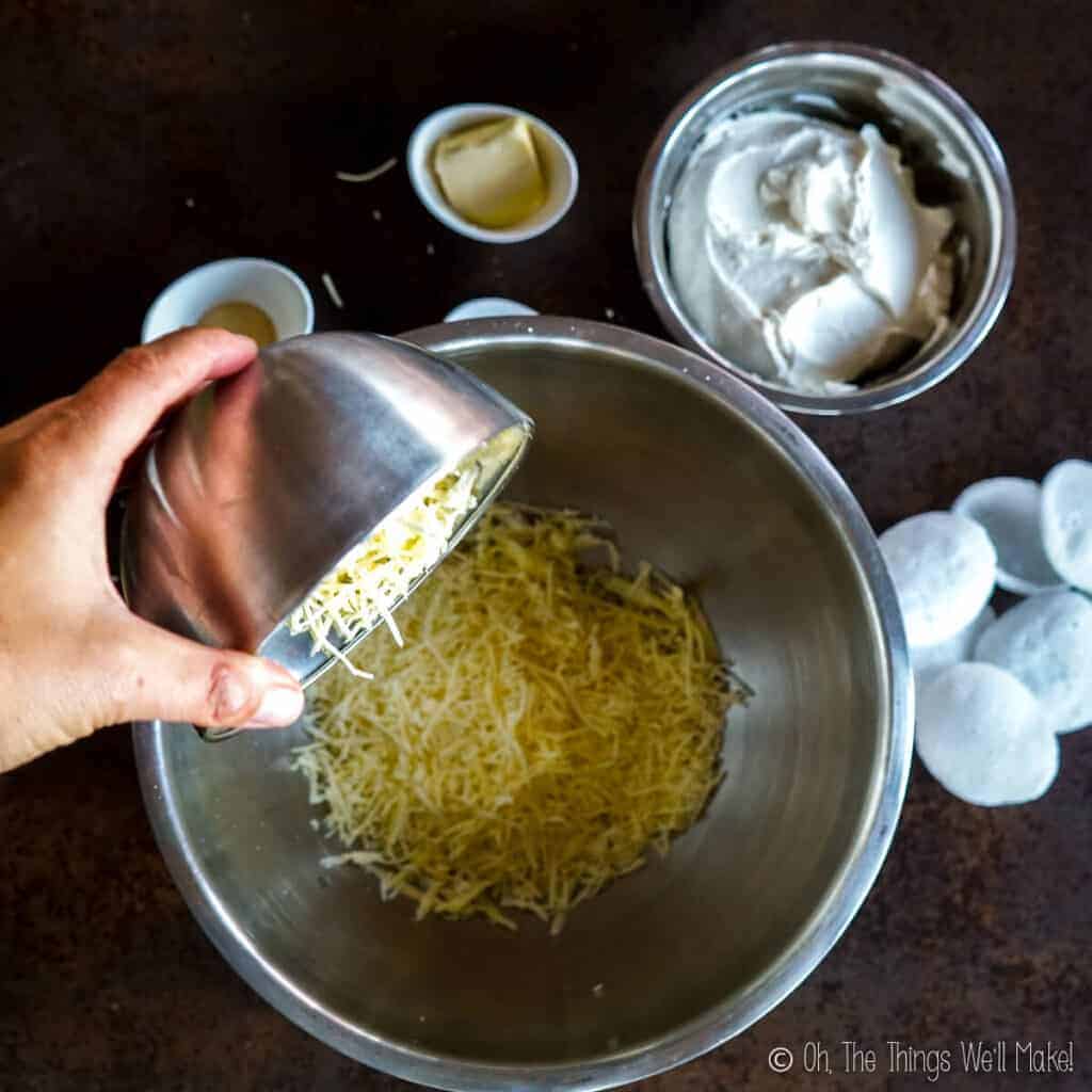 Pouring shredded cheese into a bowl