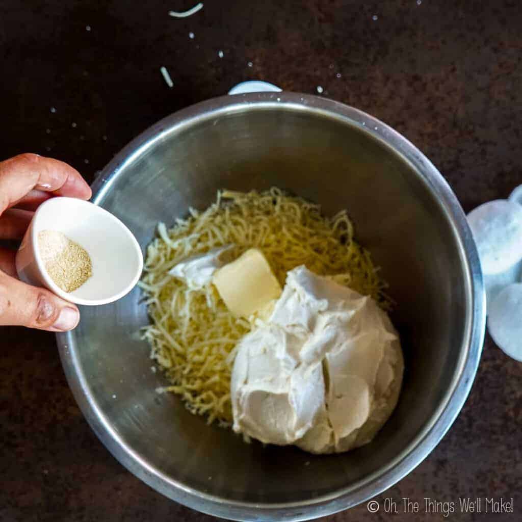 Adding garlic powder to the bowl