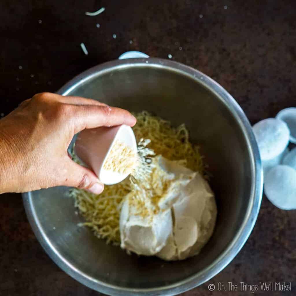 Adding onion powder to the bowl