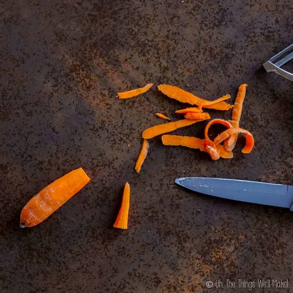 peeling a carrot and cutting the tip off