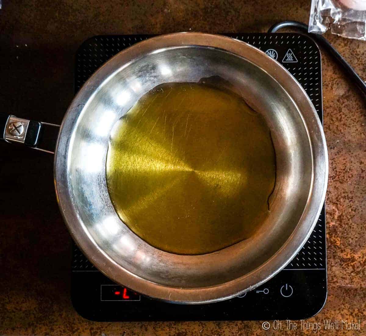 Overhead view of a pan with olive oil in it.