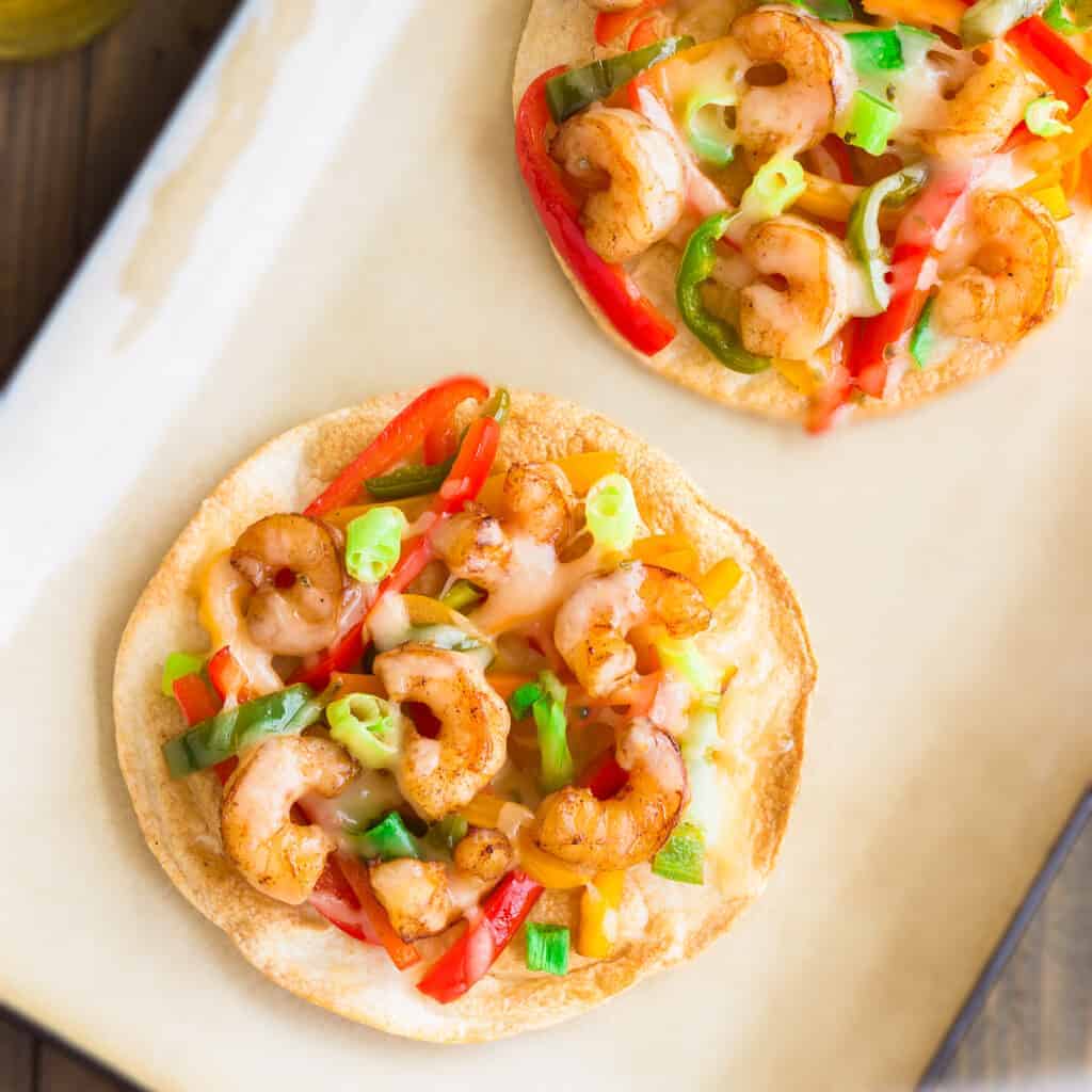 A Mexican tortilla pizza with shrimp on it