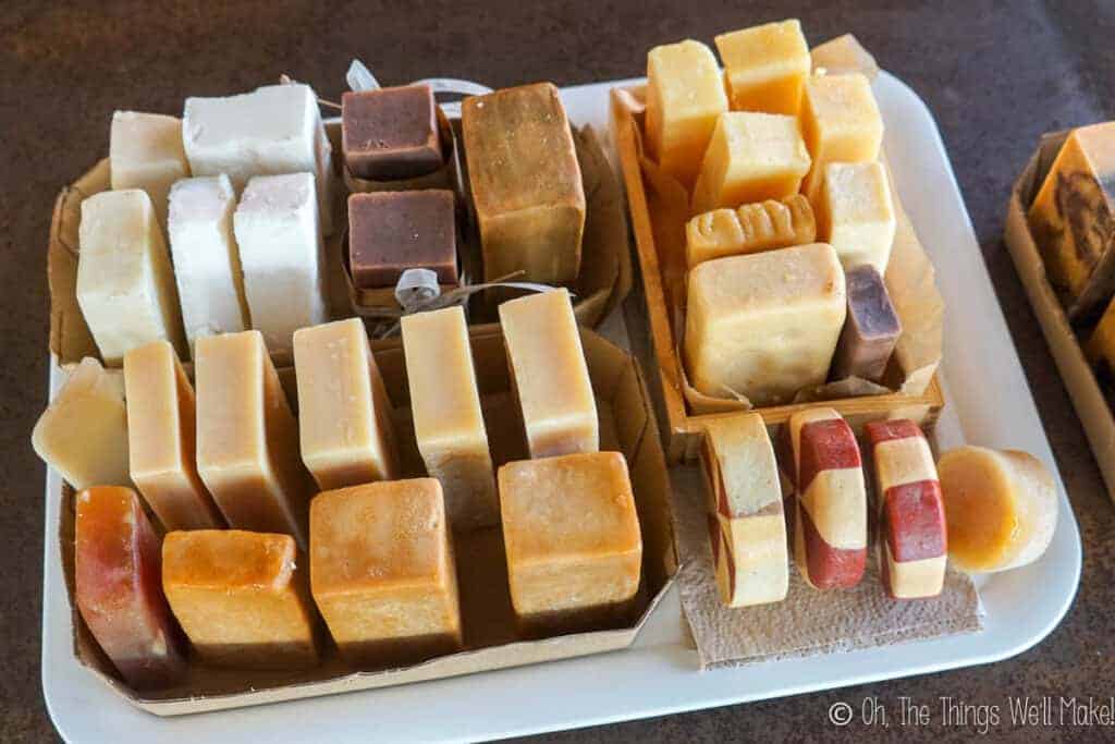 Overhead view of many groups of soaps curing on a tray