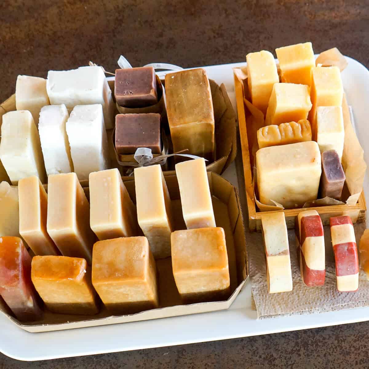 Overhead view of many groups of soaps curing on a tray