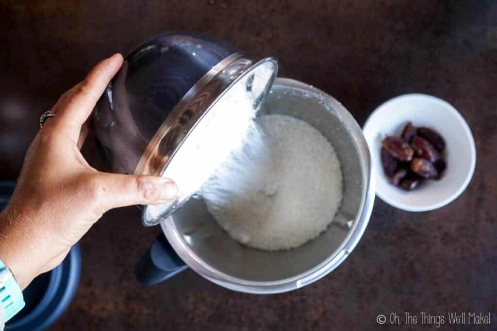 Pouring shredded coconut into a food processor