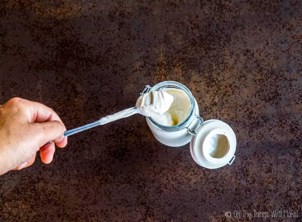The thickened cream mixture on a spoon.
