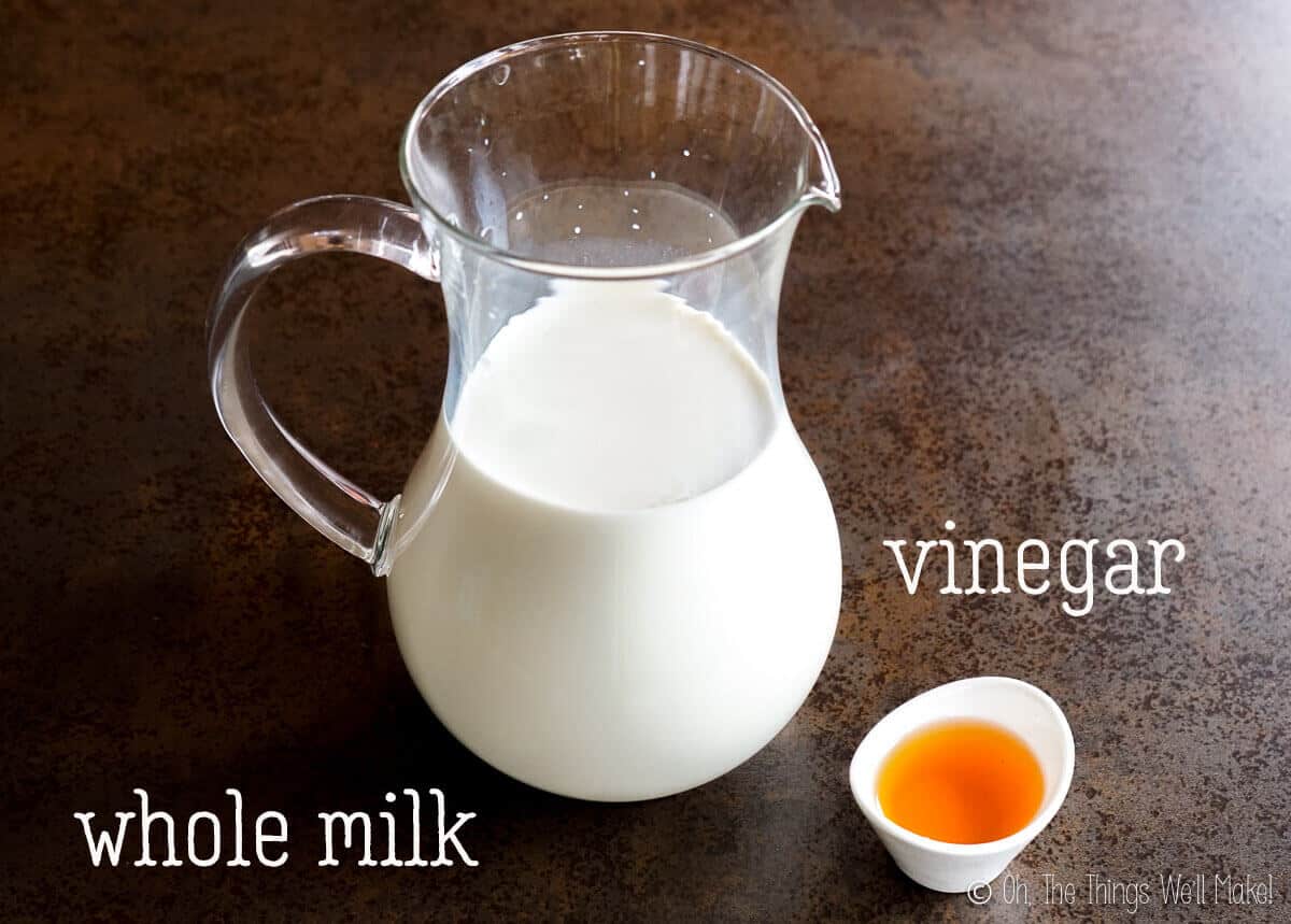 A jar of whole milk and some vinegar in a small white bowl