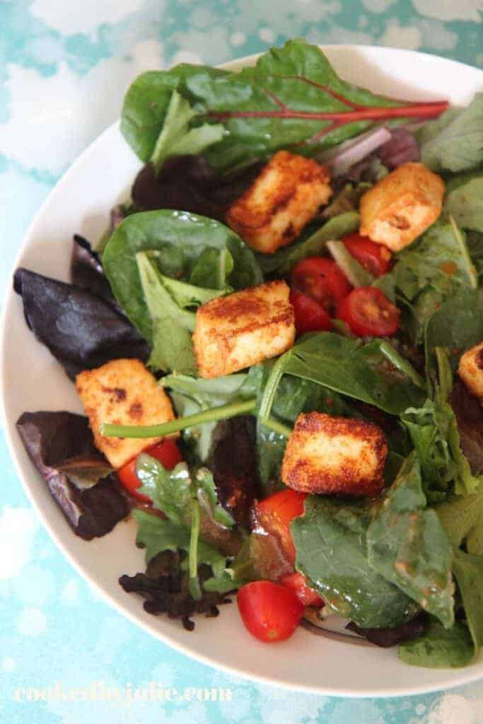 overhead view of a salad garnished with fried paneer