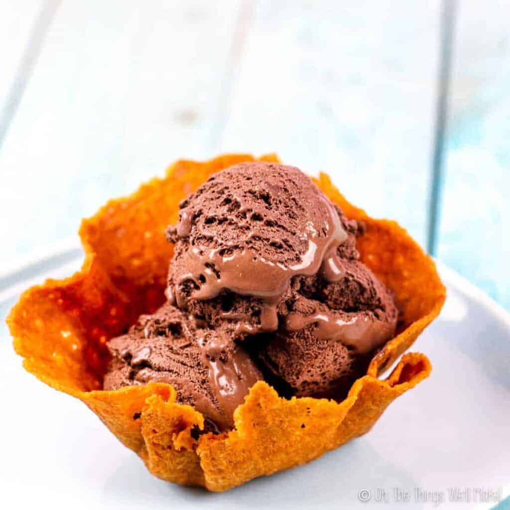 Closeup of a homemade waffle bowl filled with chocolate ice cream.