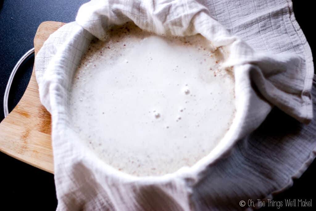 A bowl lined with a cotton cloth and filled with tigernut milk