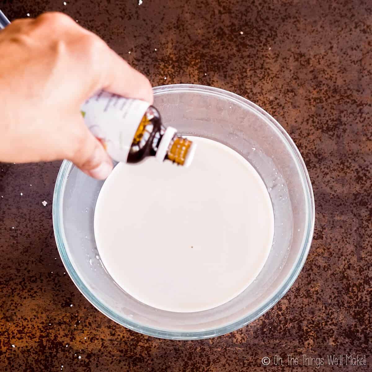 Adding drops of stevia extract to a bowl of tigernut milk