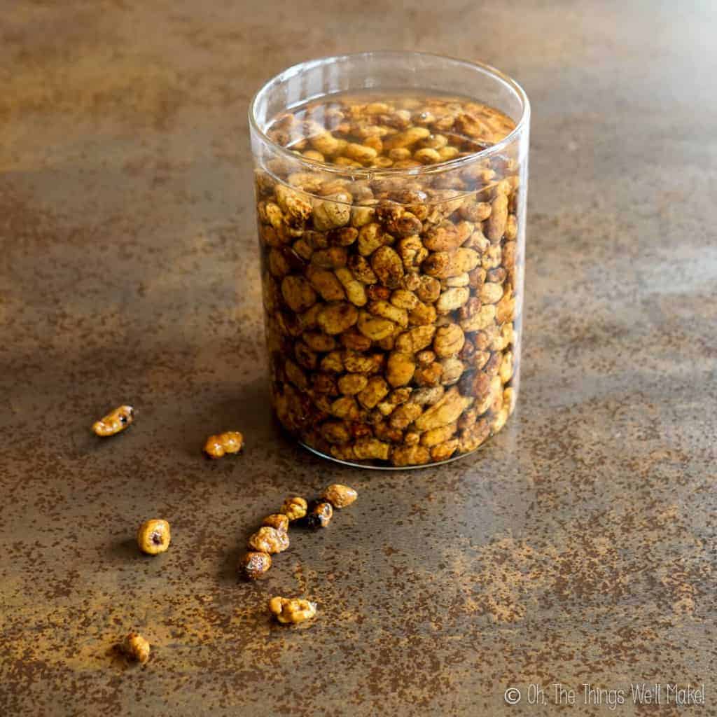 Tigernuts being soaked in water in a glass jar