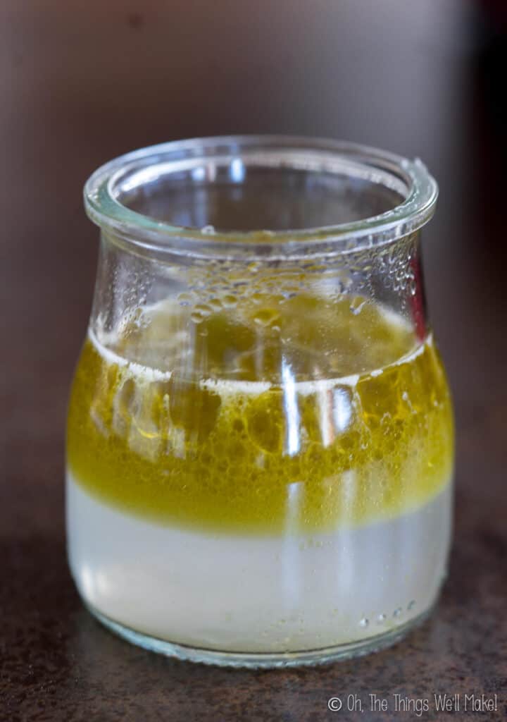 a Jar with oils floating on top of a water layer