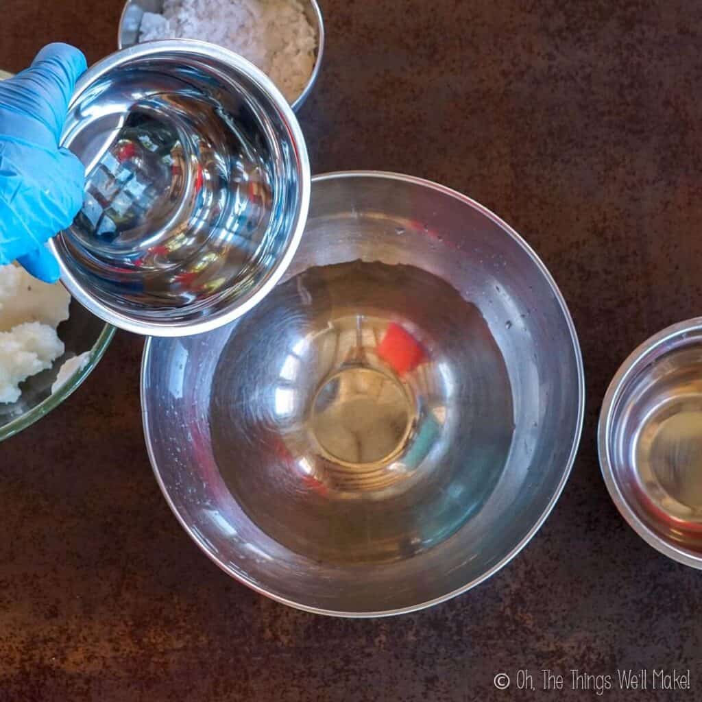 Pouring water into a bowl with glycerin