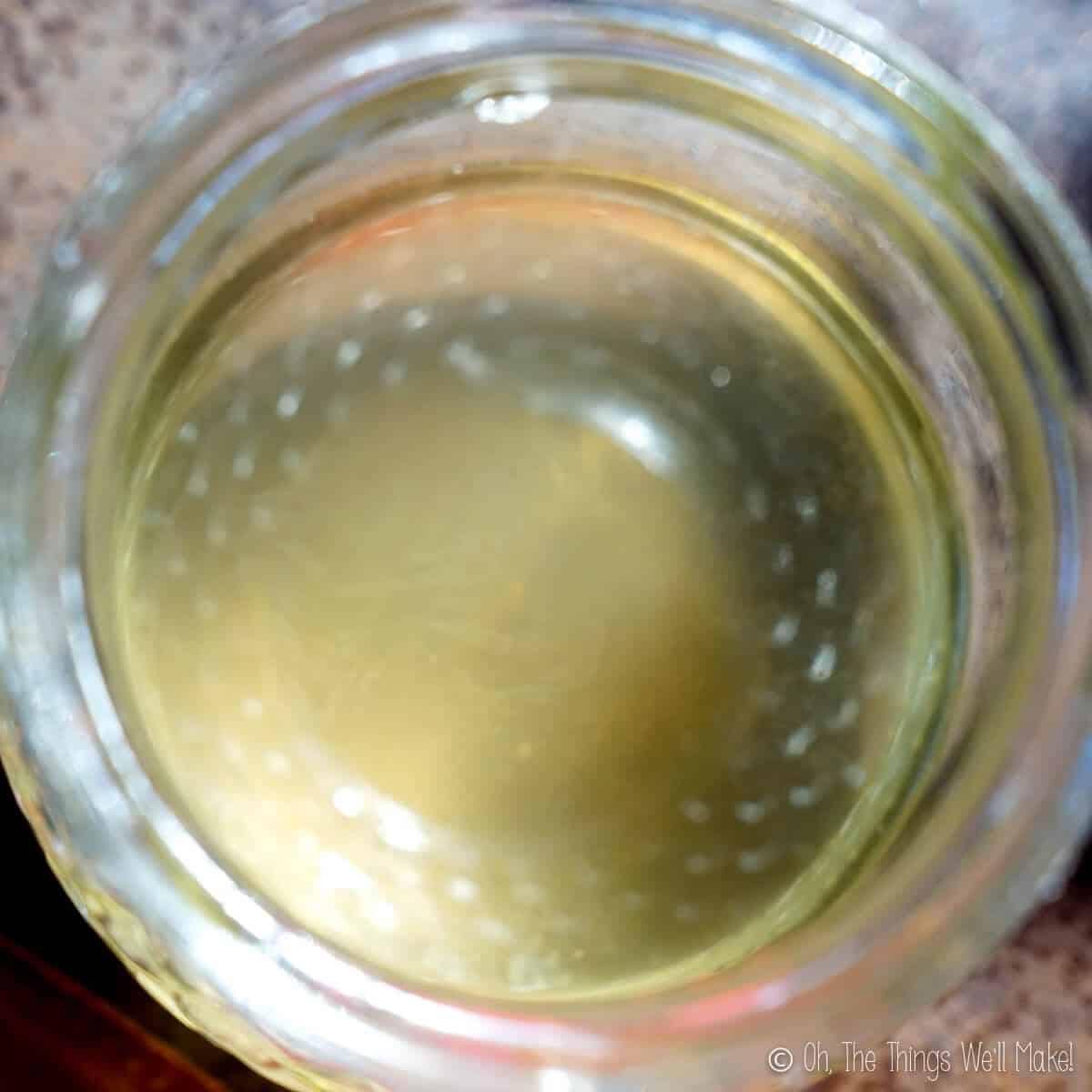 oily layer floating on the surface of liquid soap