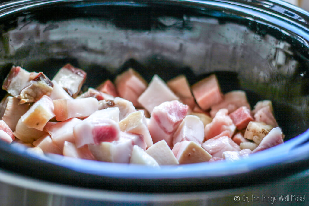 pork fat pieces in a slow cooker