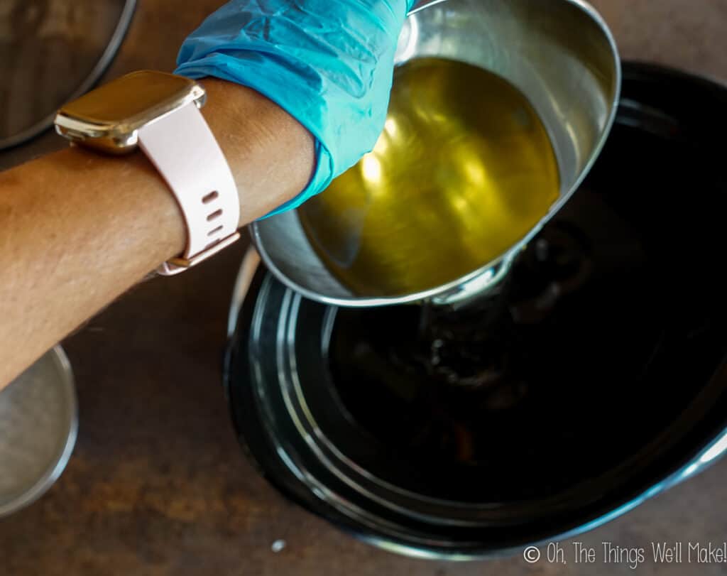 Pouring olive oil into a slow cooker