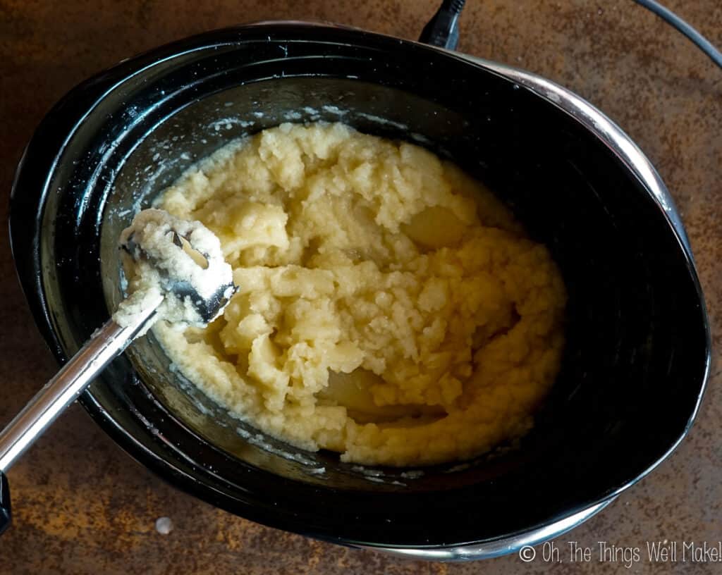 Overhead view of a grainy soap mixture in a slow cooker