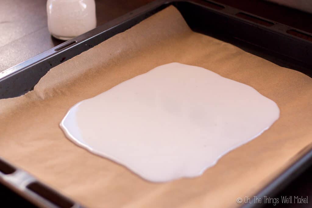 coconut butter poured over a baking sheet with parchment paper