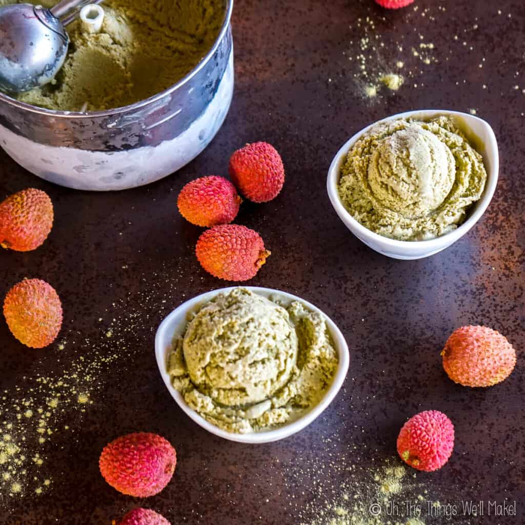 overhead view of 2 bowls of matcha lychee ice cream surrounded by lychees and matcha powder