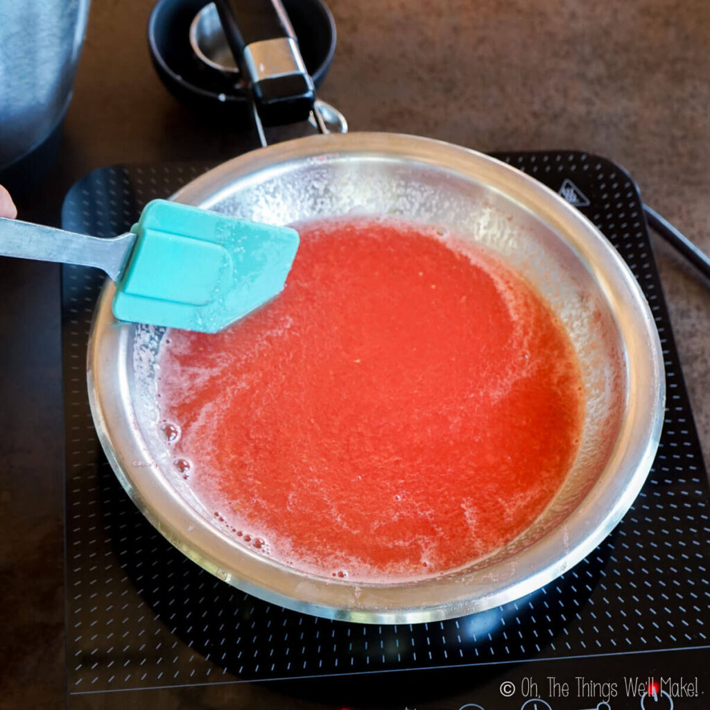 A saucepan with some watermelon purée and gelatin.