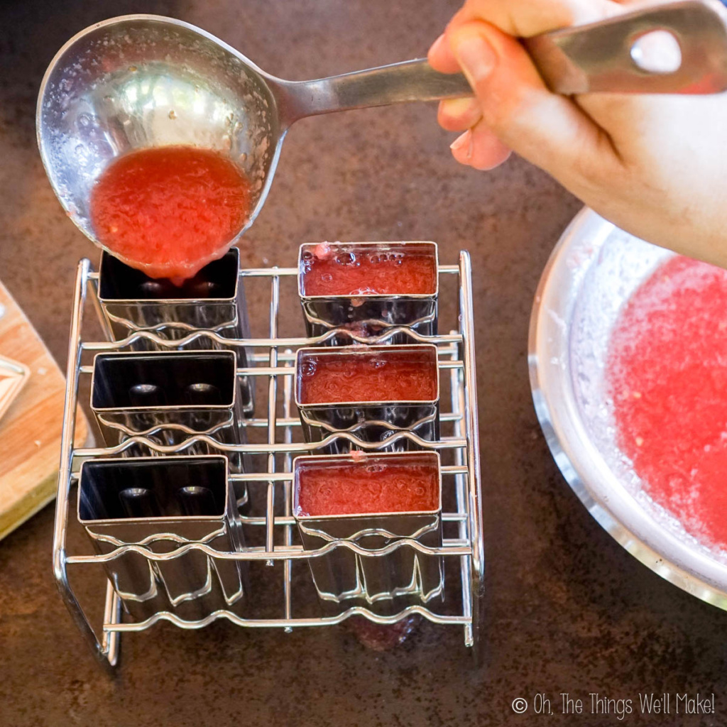 ladeling the gelatin mixture into popsicles molds