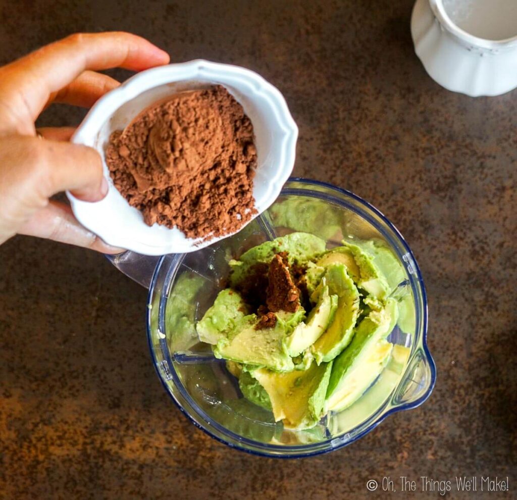 Adding cocoa powder to the blender