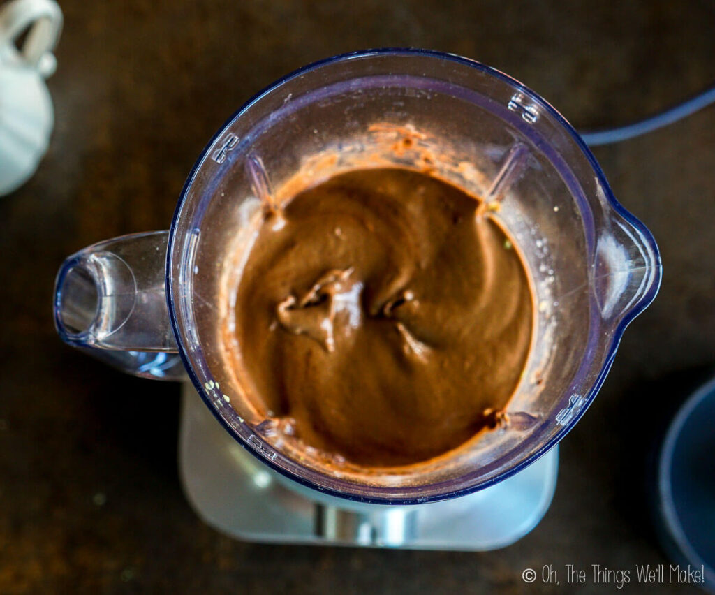 Overhead view of the chocolate avocado pudding mixture in the blender