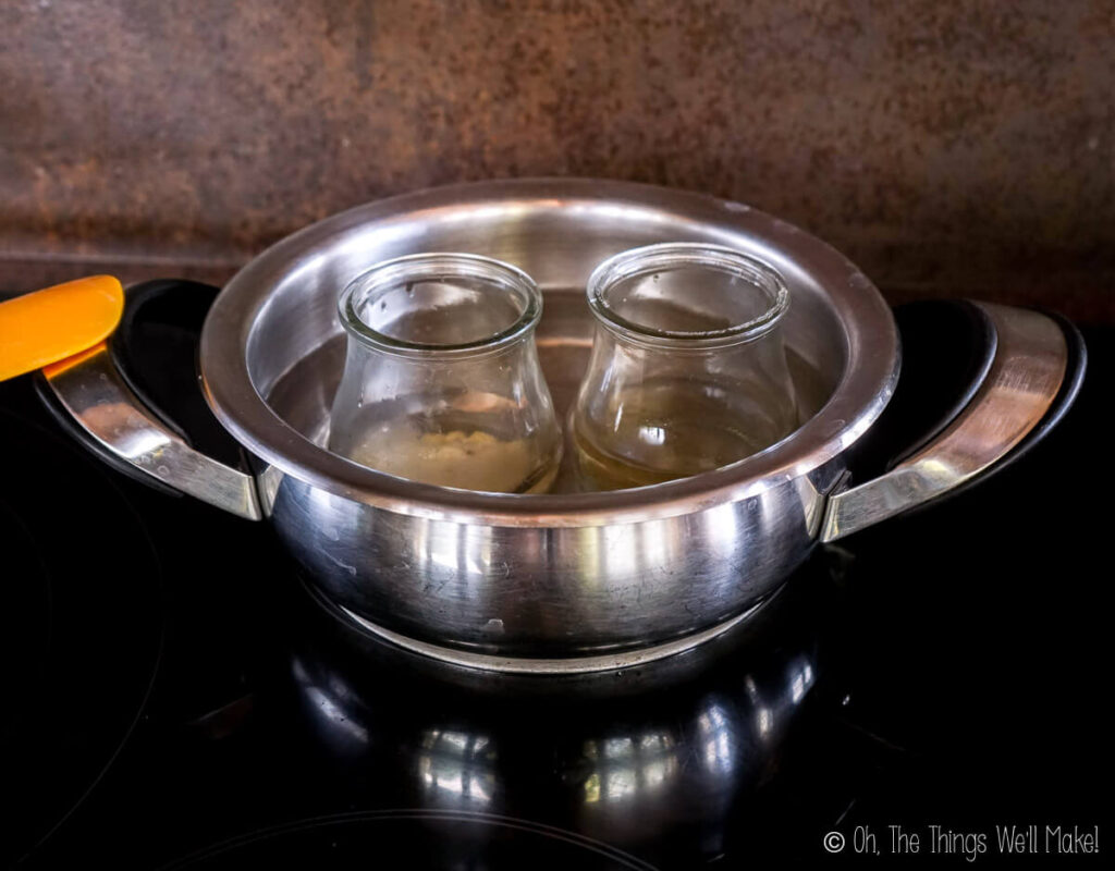 Two jars of ingredients in water in a pot