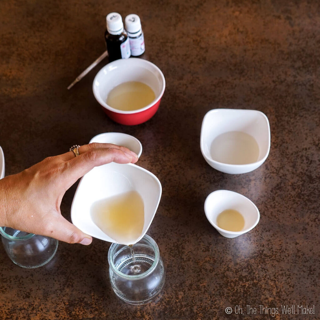 Pouring aloe juice into a glass jar